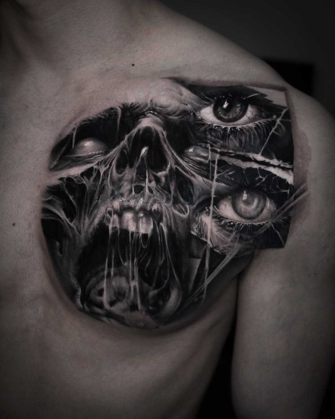Skull and eyes dark art tattoo on the chest by Pitasso tattoo black and grey
