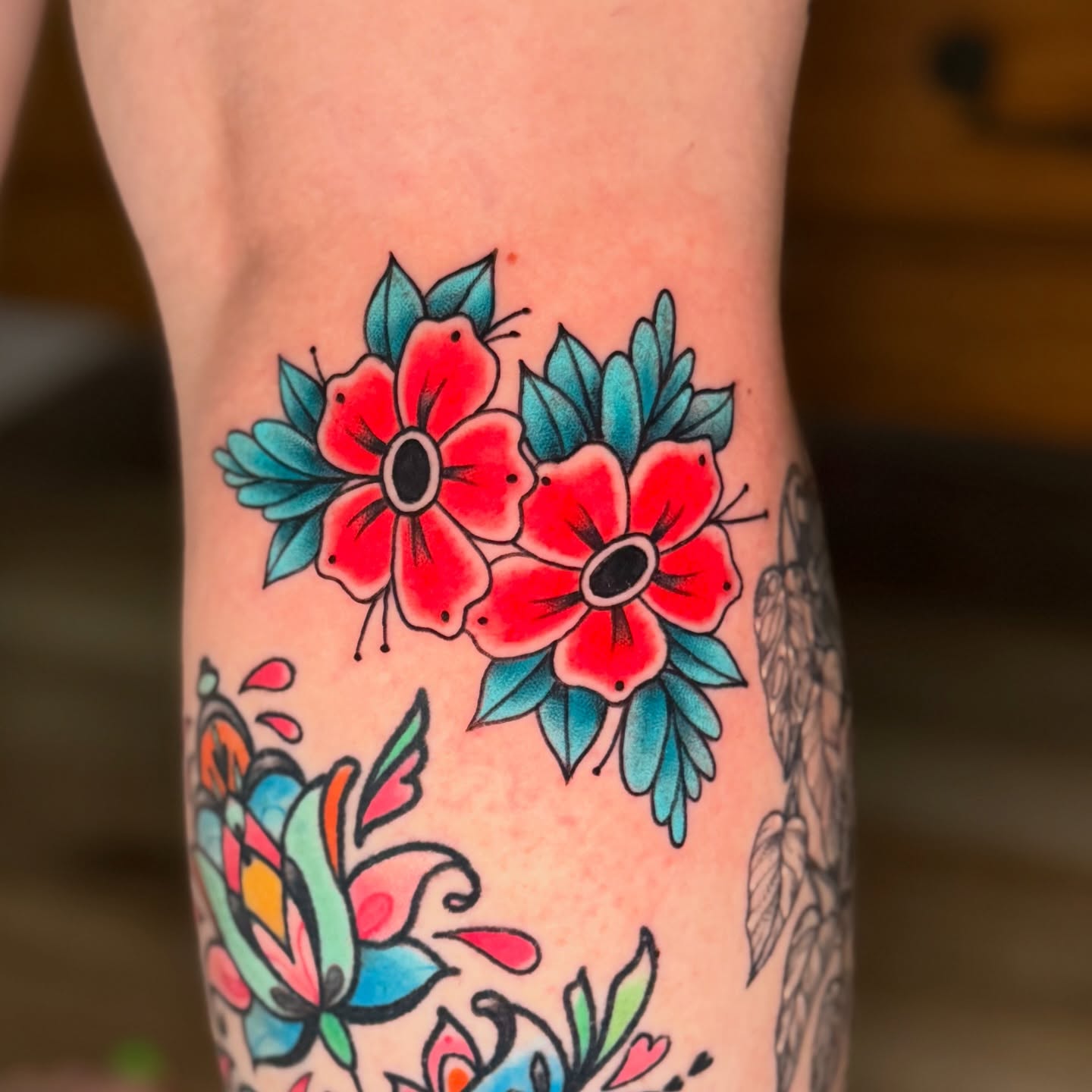 Red flowers American traditional tattoo on the forearm by Chiah