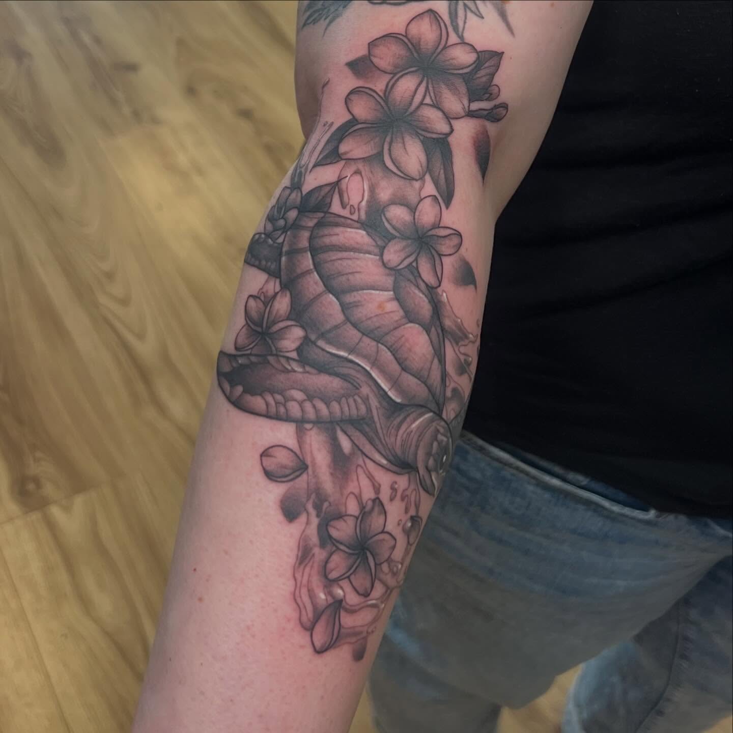 Seahorse and flowers black and grey tattoo on the forearm by Bailey Goodwin, Ankeny, Iowa