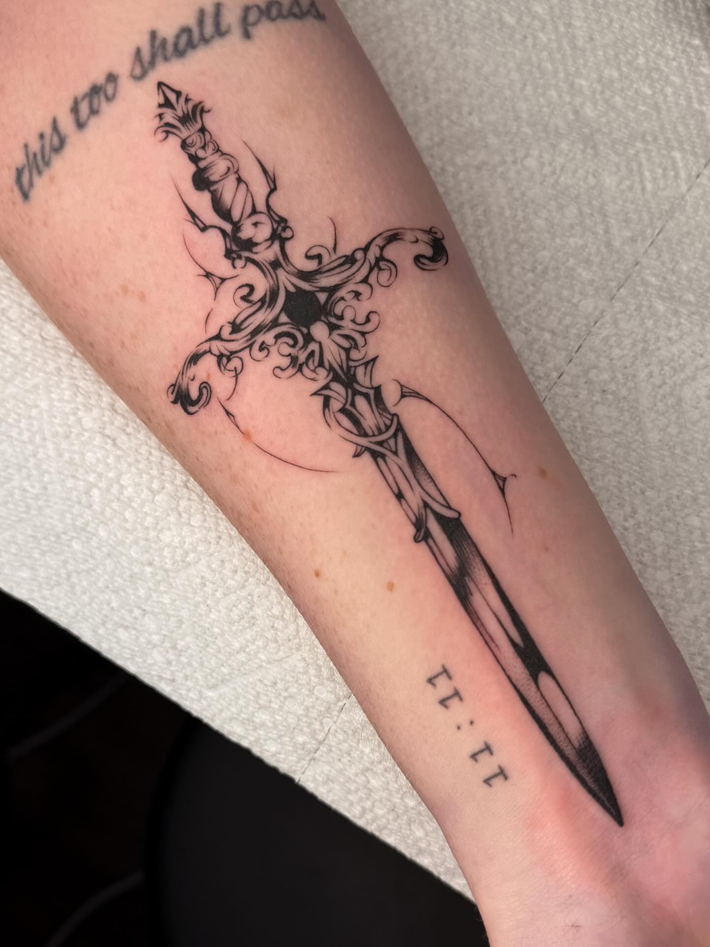 Cross and sword ornamental tattoo on the forearm by Maggie Angulo