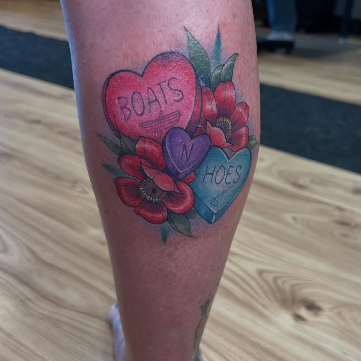 Heart-shaped candy American traditional tattoo on the calf by Bailey Goodwin, Ankeny, Iowa