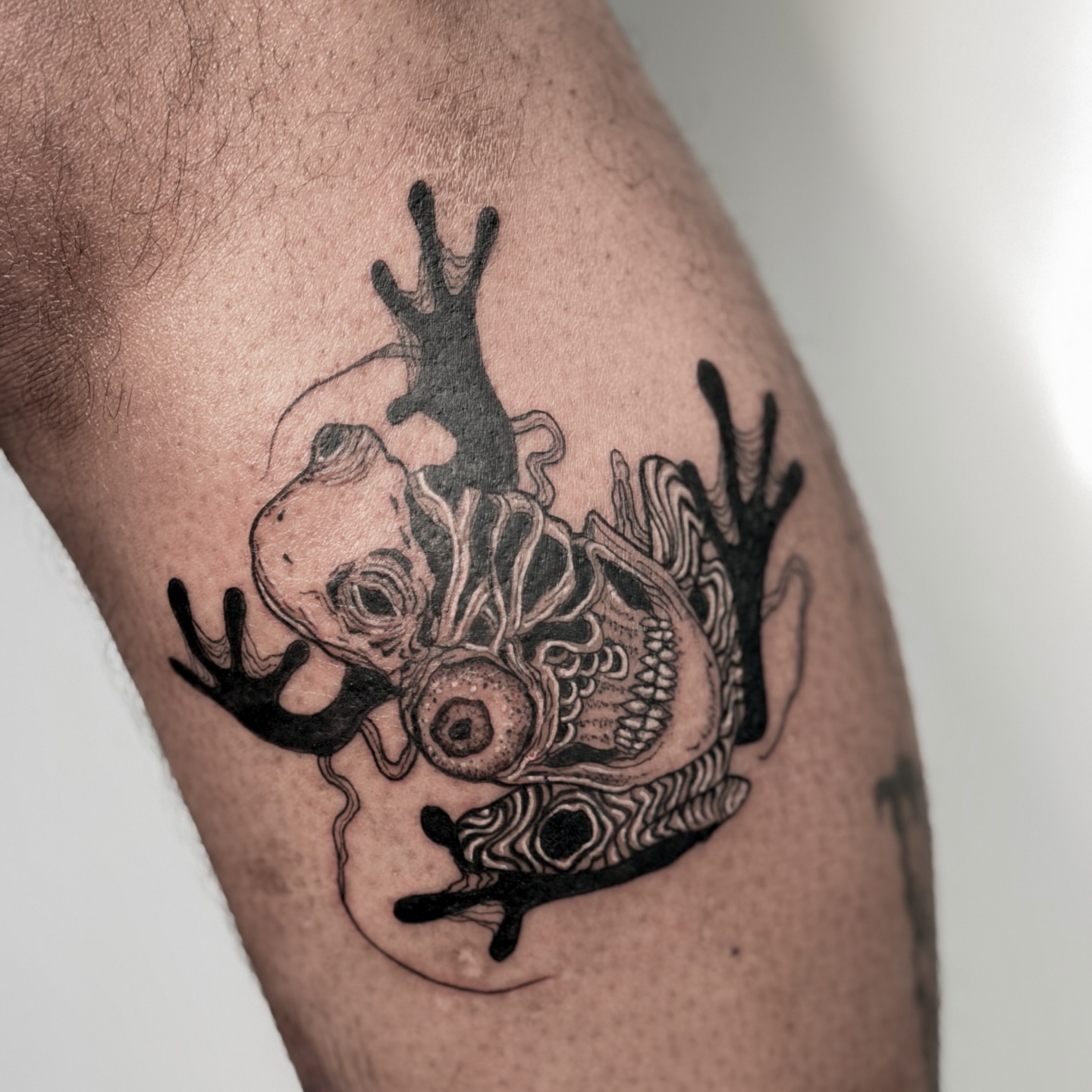 Heart with tentacles surrealism tattoo on the thigh by Tatuajes Denver