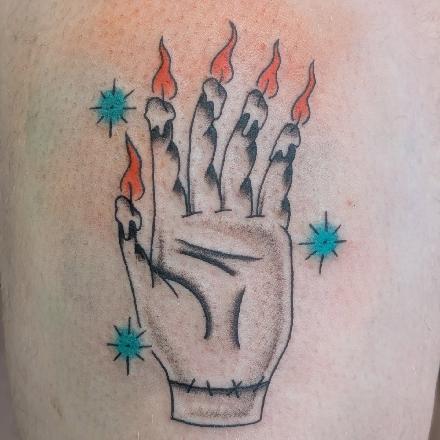 Hand with candles American traditional tattoo on the forearm by Alexandria Green