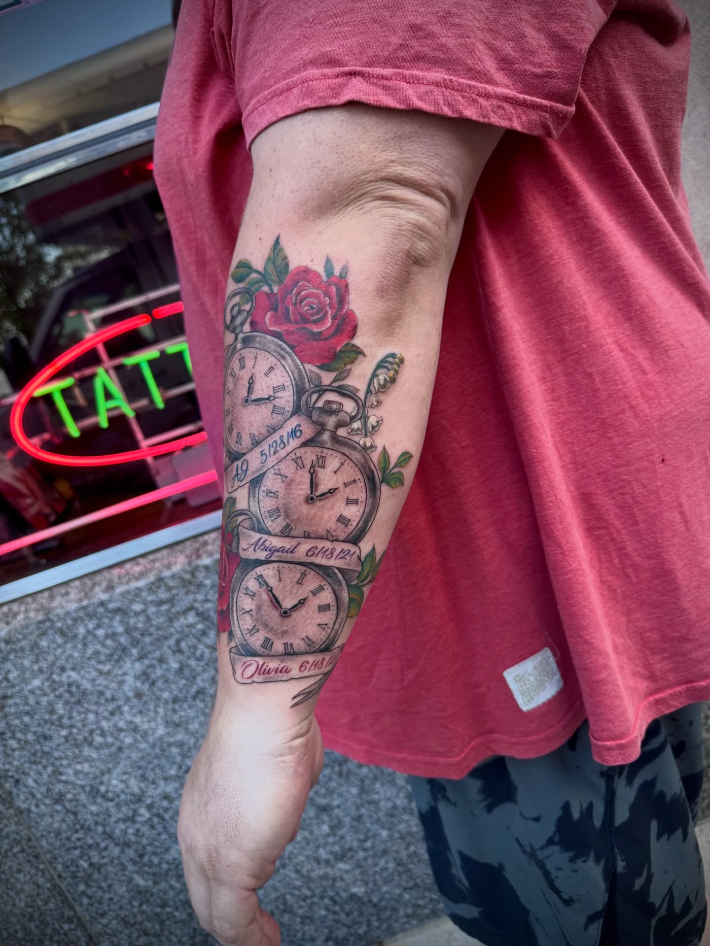Pocket watch and roses American traditional tattoo on the forearm by Kylie Allen