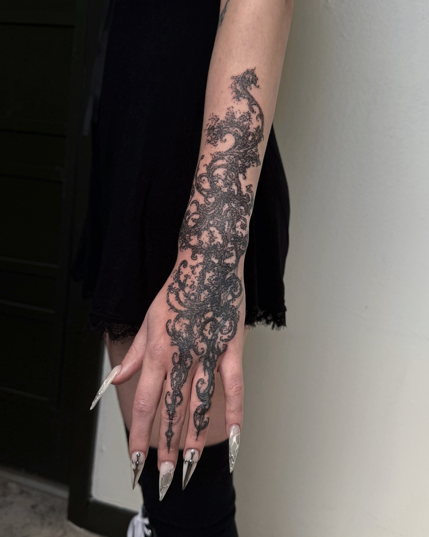 Lace pattern black and grey tattoo on the upper arm by Penelope