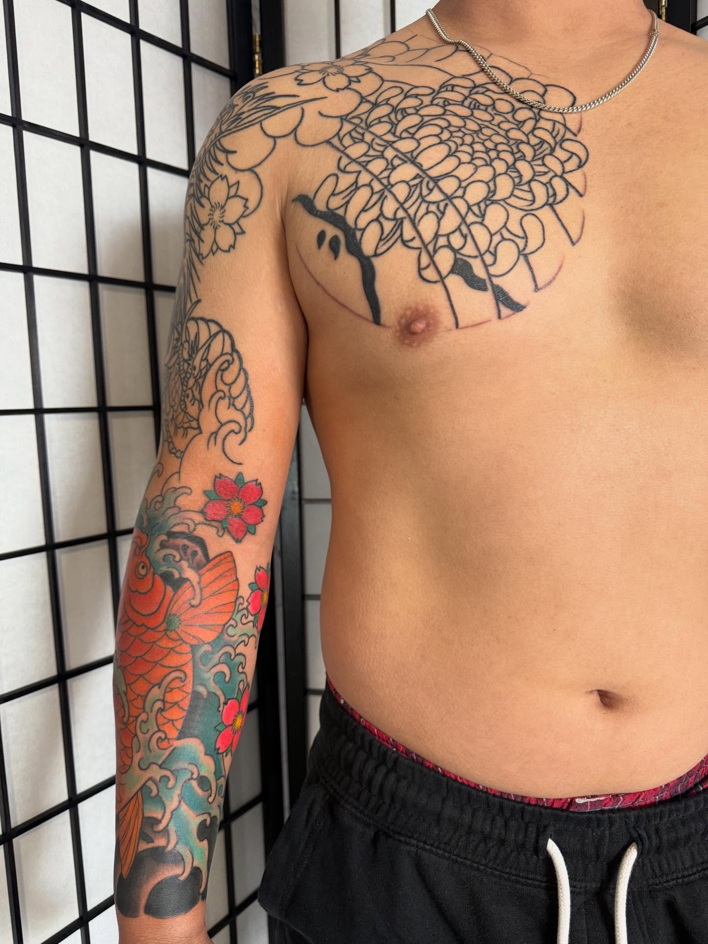 Chrysanthemum American traditional tattoo on the chest by Randall Croley El