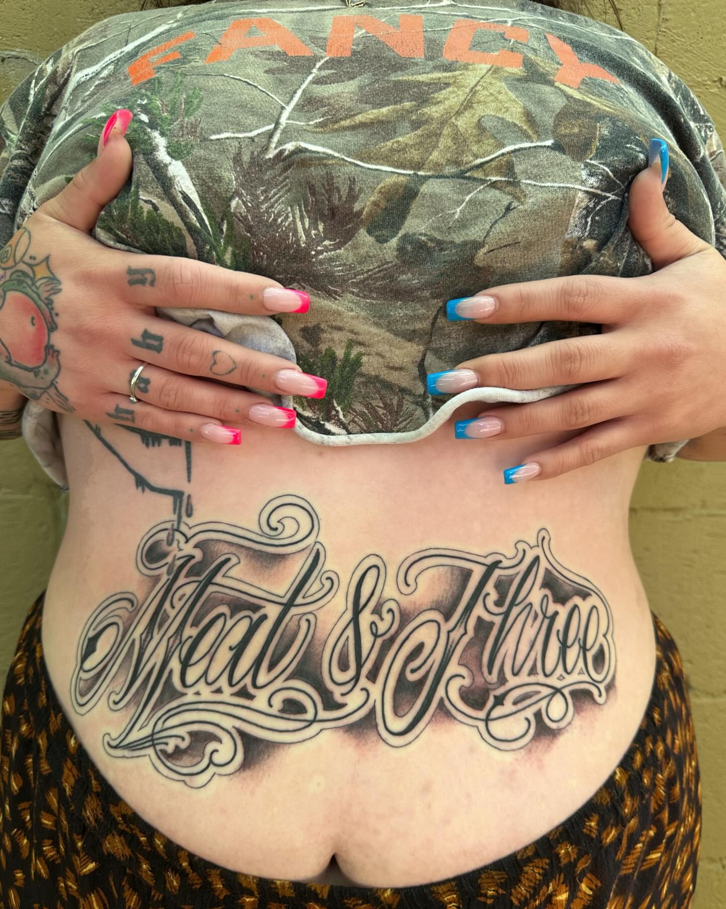 Meat & Three lettering script tattoo on the torso by Mim