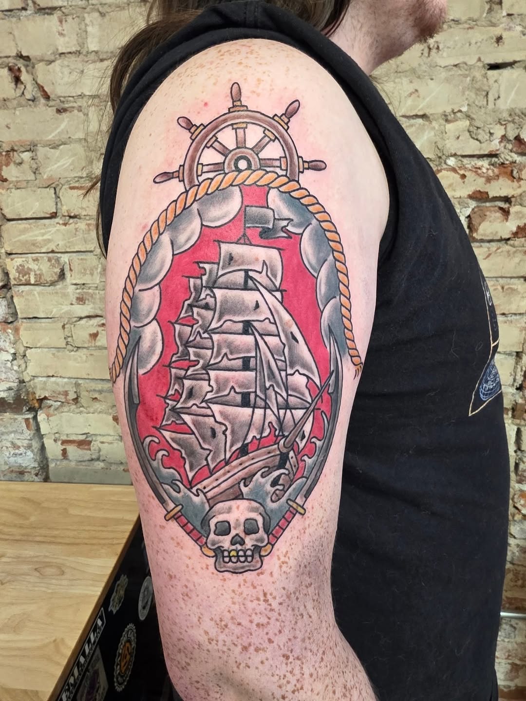 Pirate ship with skull and swords American traditional tattoo on the shoulder by Tattoos by Annie