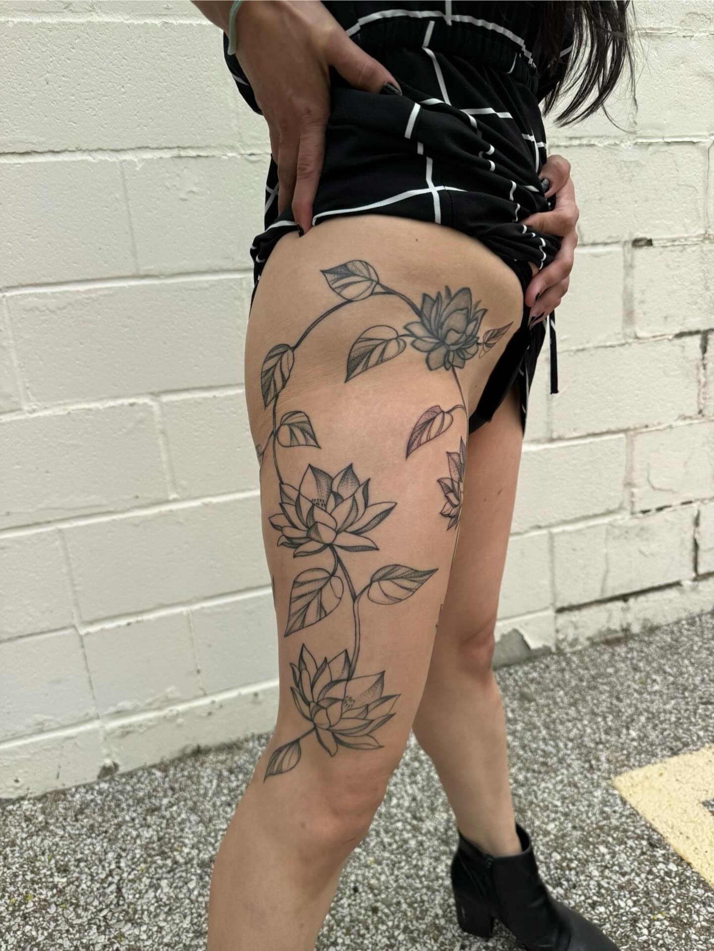 Lotus flowers black and grey tattoo on the thigh by Max
