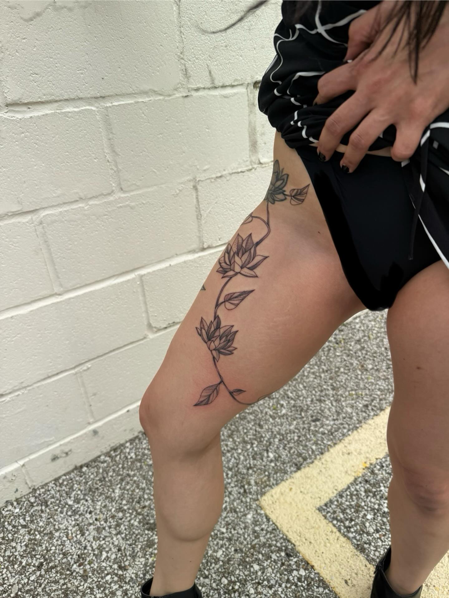 Lotus flowers black and grey tattoo on the thigh by Max