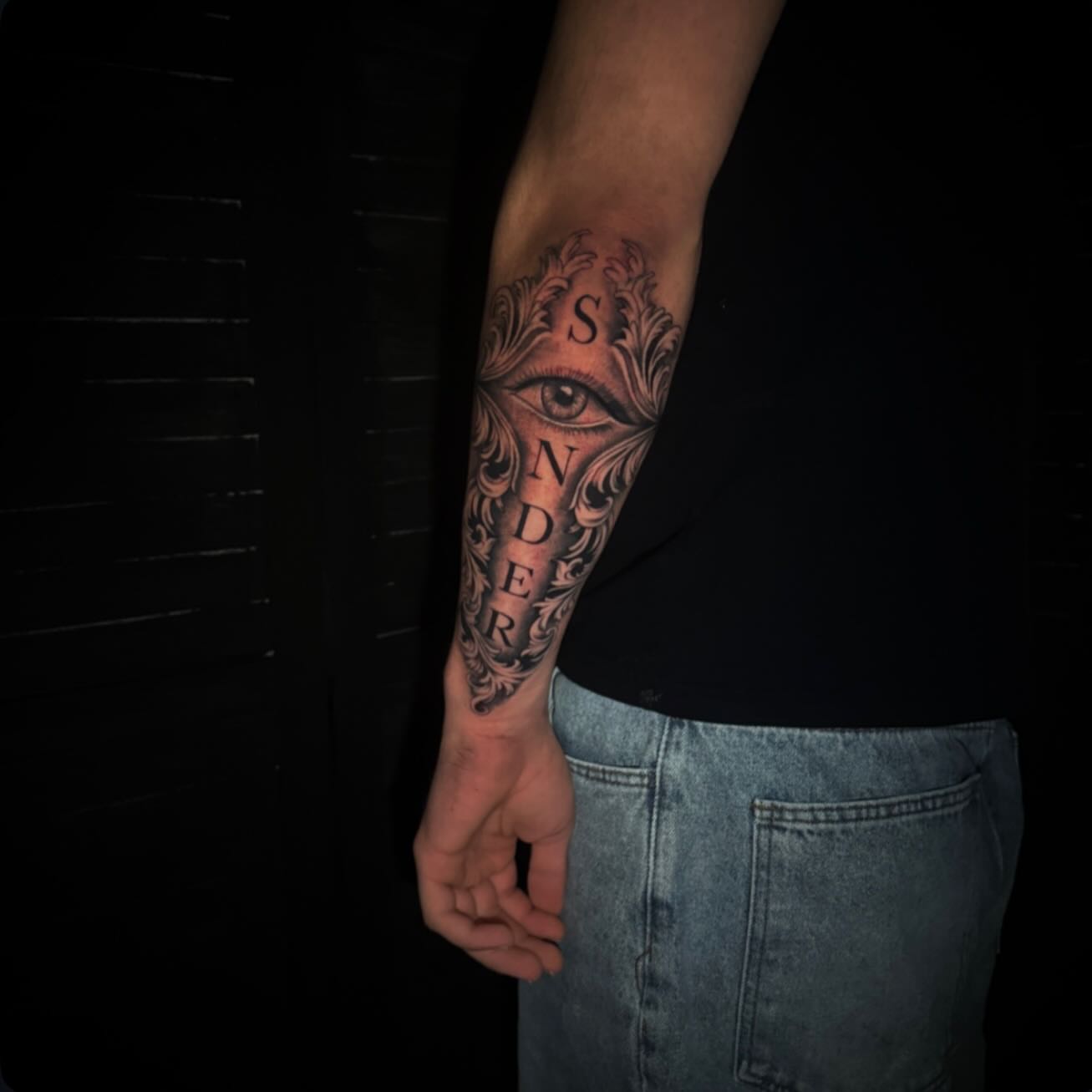 Eye black and grey tattoo on the forearm by Sad Girl Tattoos