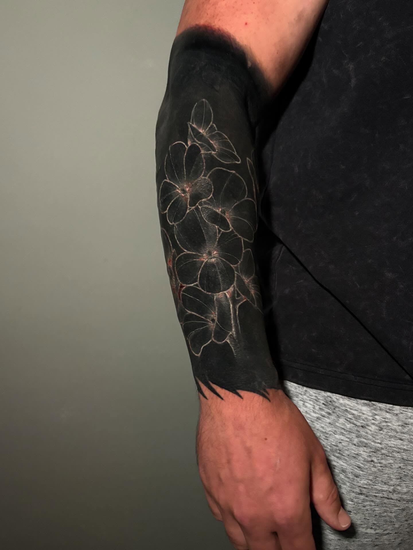 Flowers black and grey tattoo on the forearm by Cameron Scofield