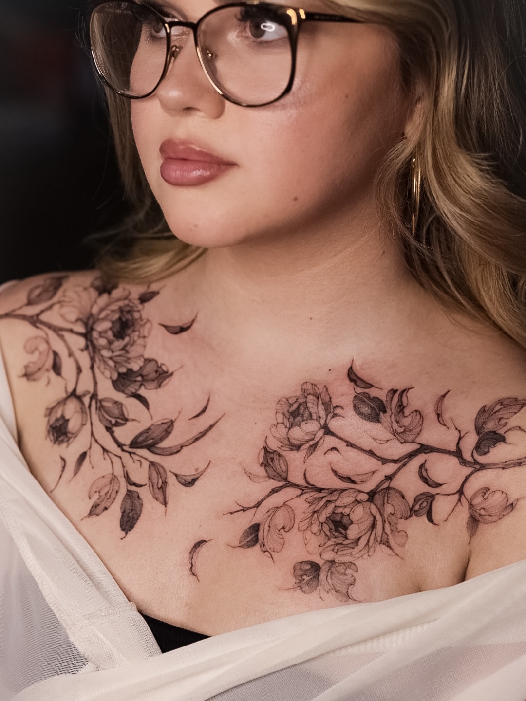 Floral black and grey tattoo on the chest by Maria