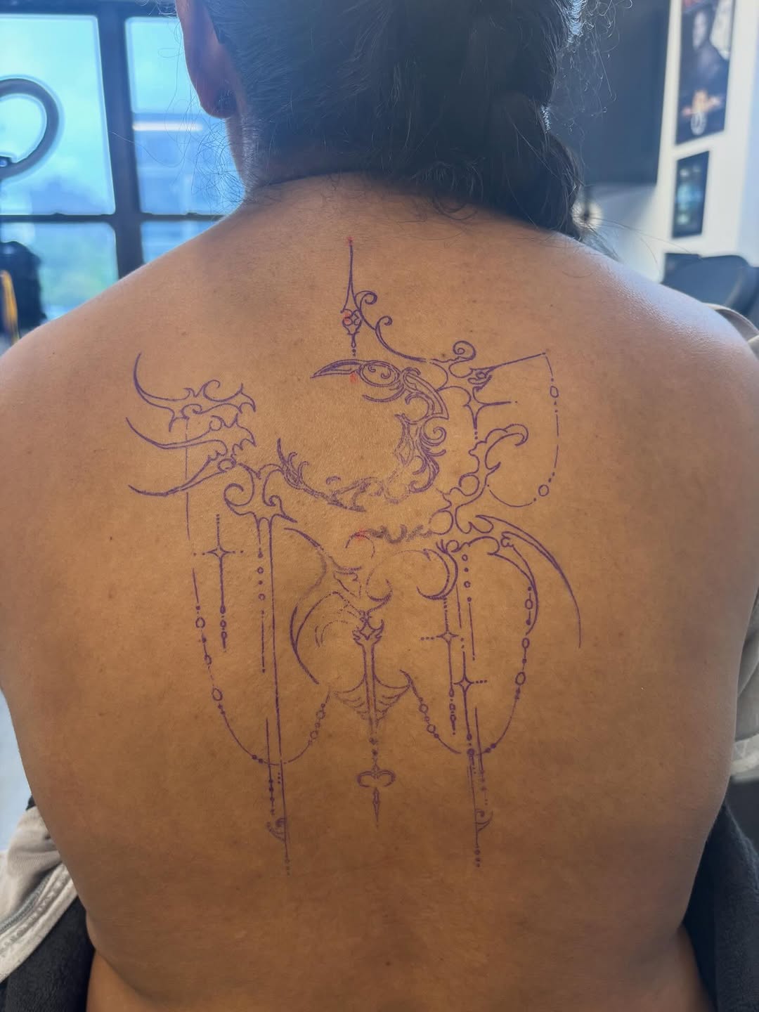 Ornamental celestial design blackwork tattoo on the back by Lopez Dautruche