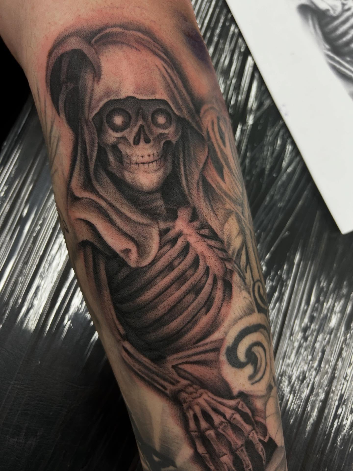 Grim reaper realism tattoo on the forearm by Mayhem Andrews