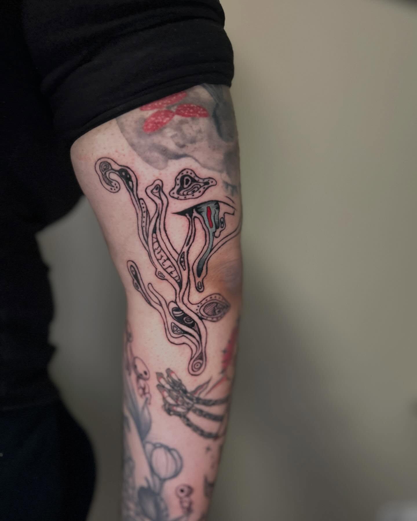 Octopus tentacles black and grey tattoo on the forearm by Alex