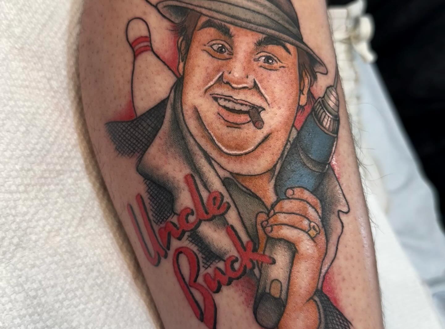 Uncle Buck realism tattoo on the forearm by Mikaila Rose Krauss