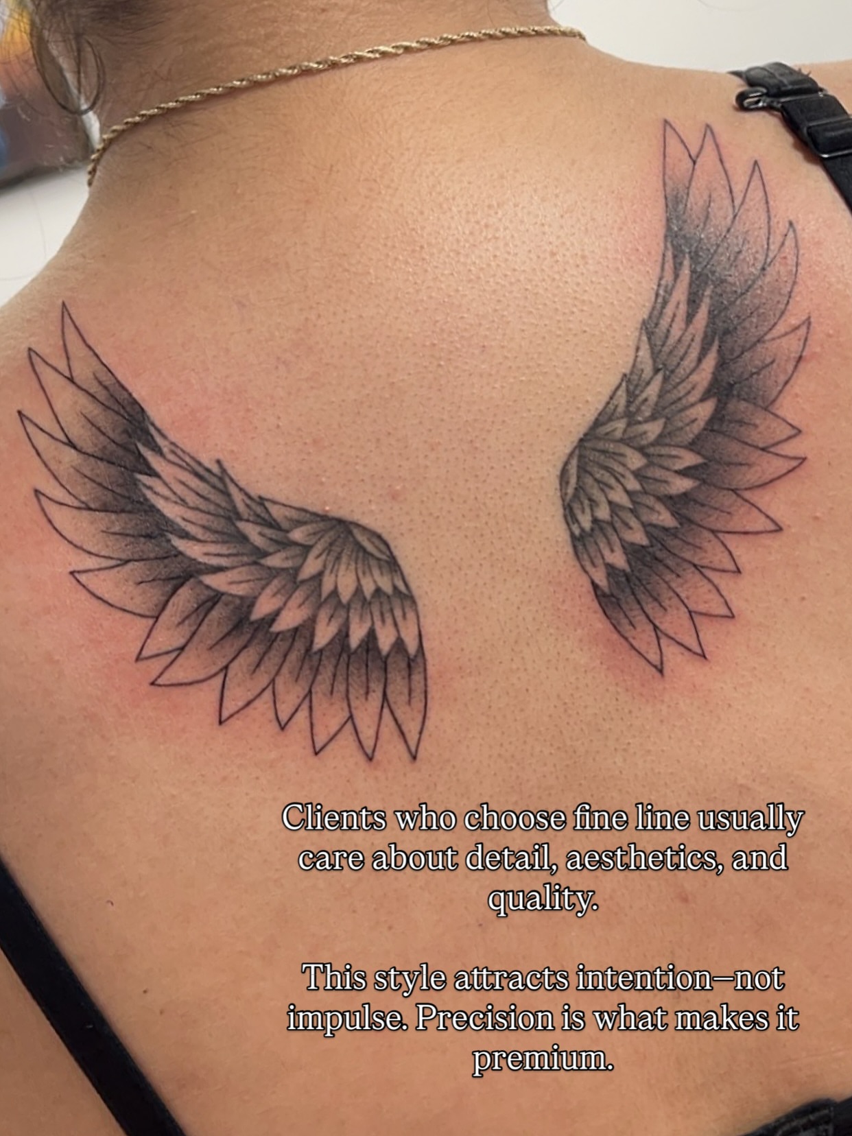 Wings fine line tattoo on the back by Royal Martinez