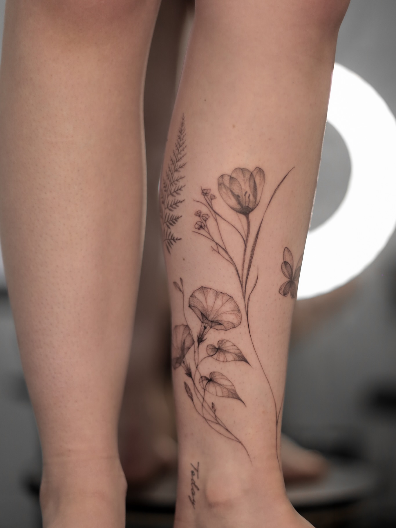 Floral arrangement realism tattoo on the calf by Inna Petrova, Kitchener, Ontario
