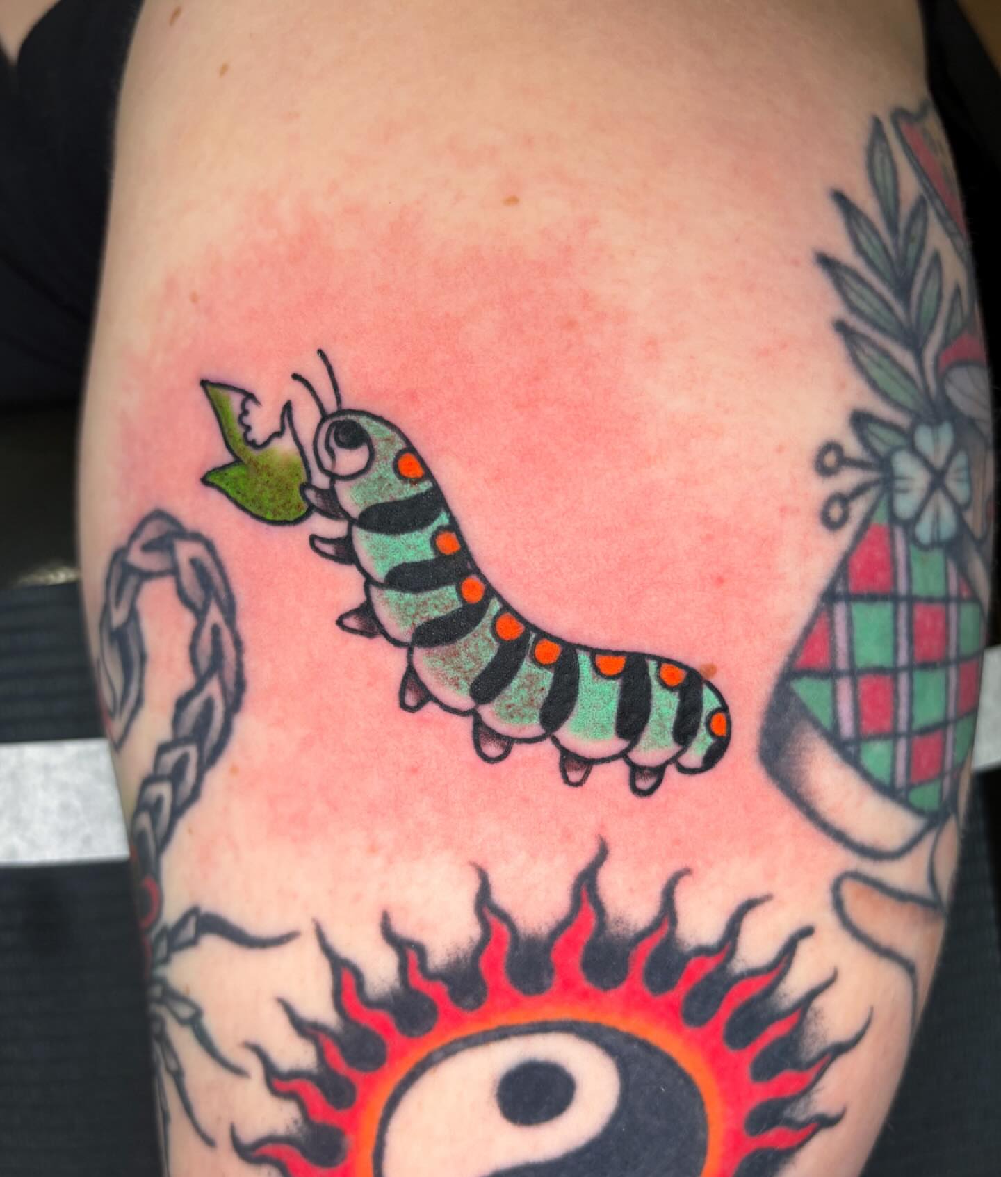 Worm American traditional tattoo on the thigh by Katelyn Spence