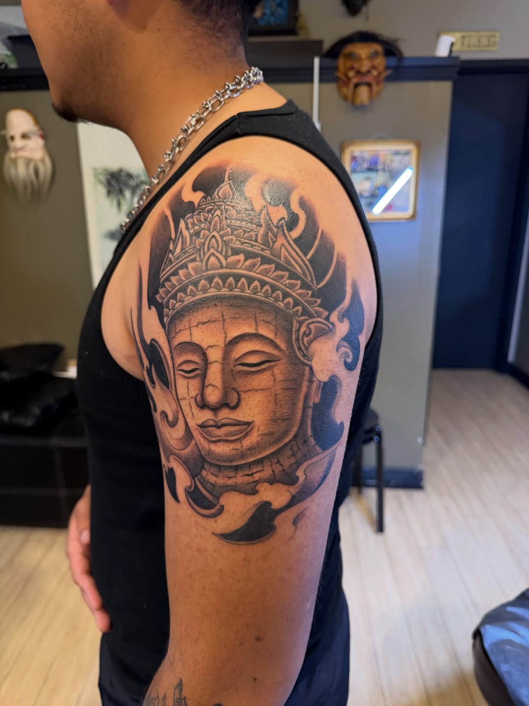 Buddha face realism tattoo on the shoulder by Winston Thai