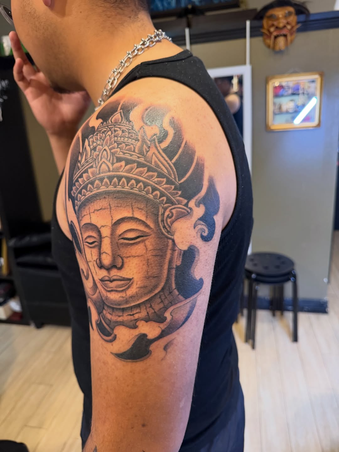 Buddha face realism tattoo on the forearm by Winston Thai