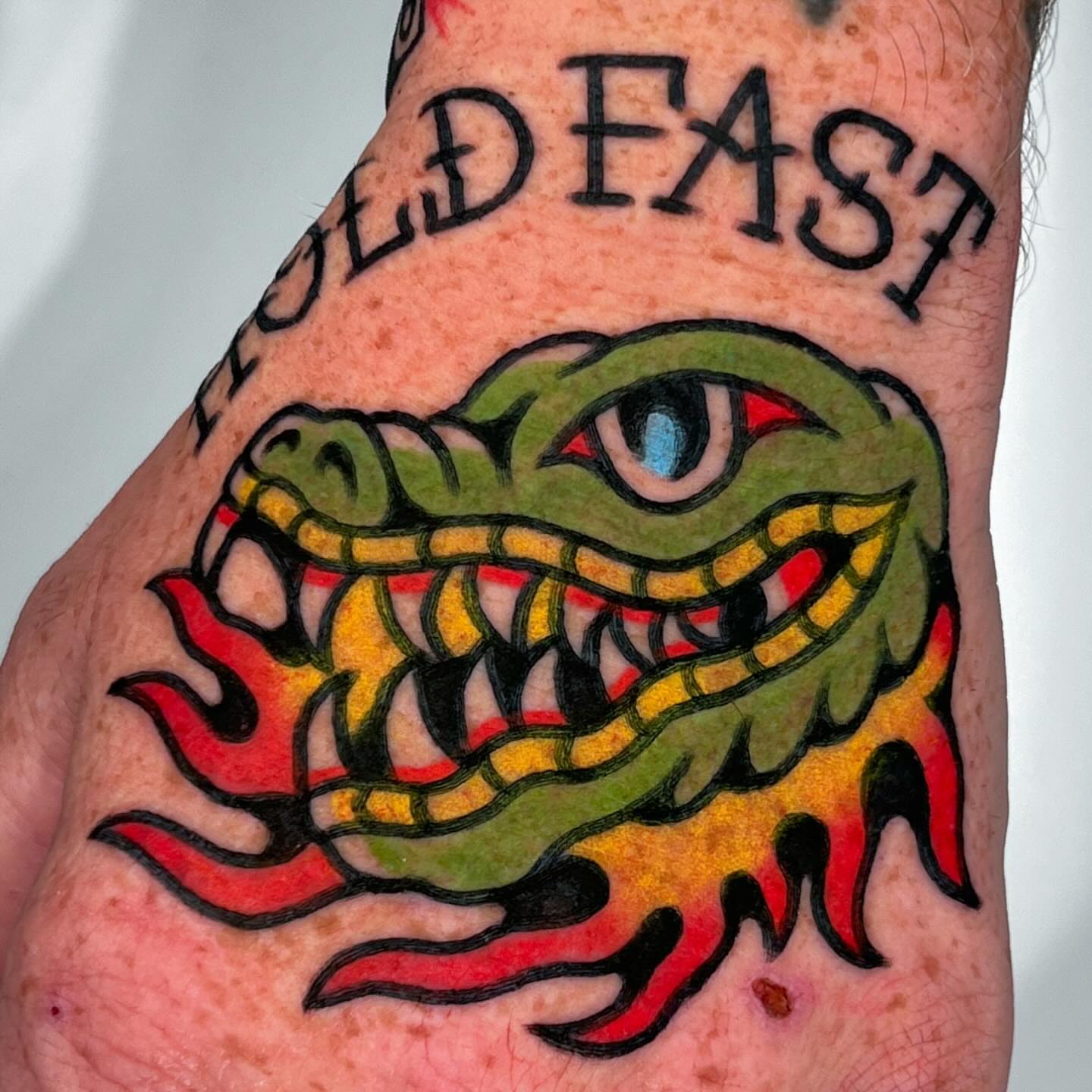 Snake American traditional tattoo on the forearm by Oldschool Tattooer Takii 타키