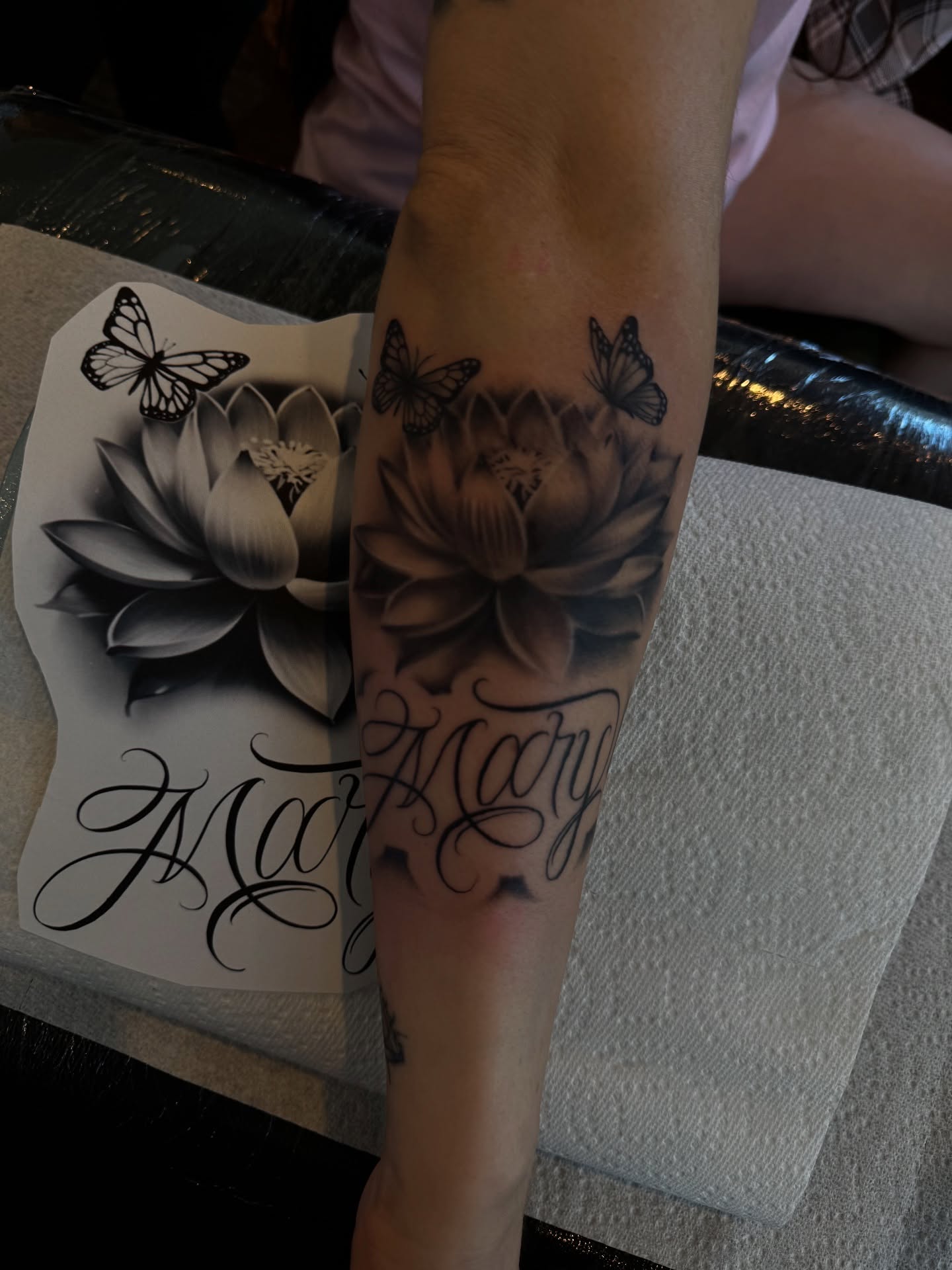 Lotus flowers and butterflies realism tattoo on the forearm by Alex Romero