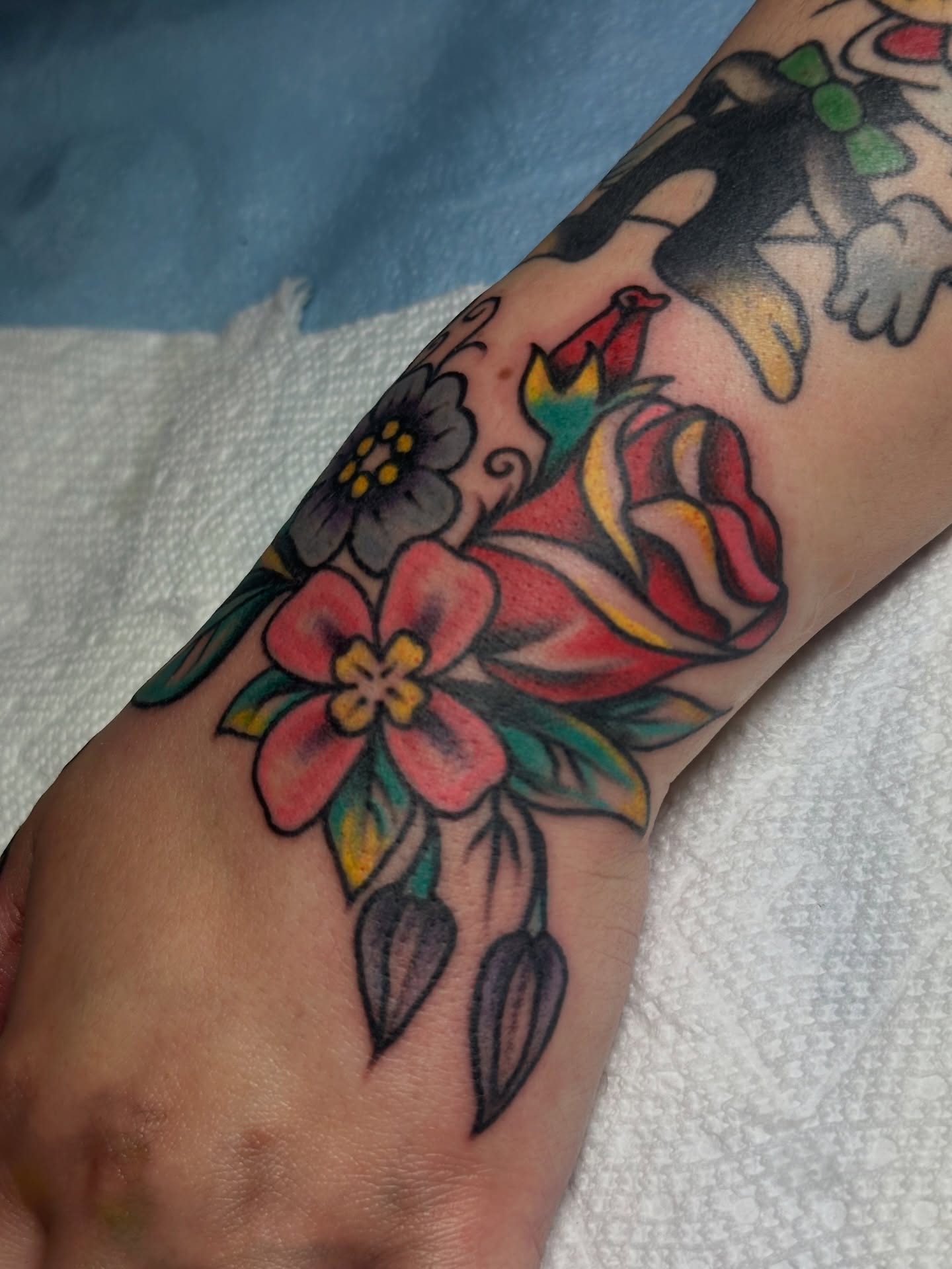 Floral bouquet American traditional tattoo on the forearm by Providence Tattooer