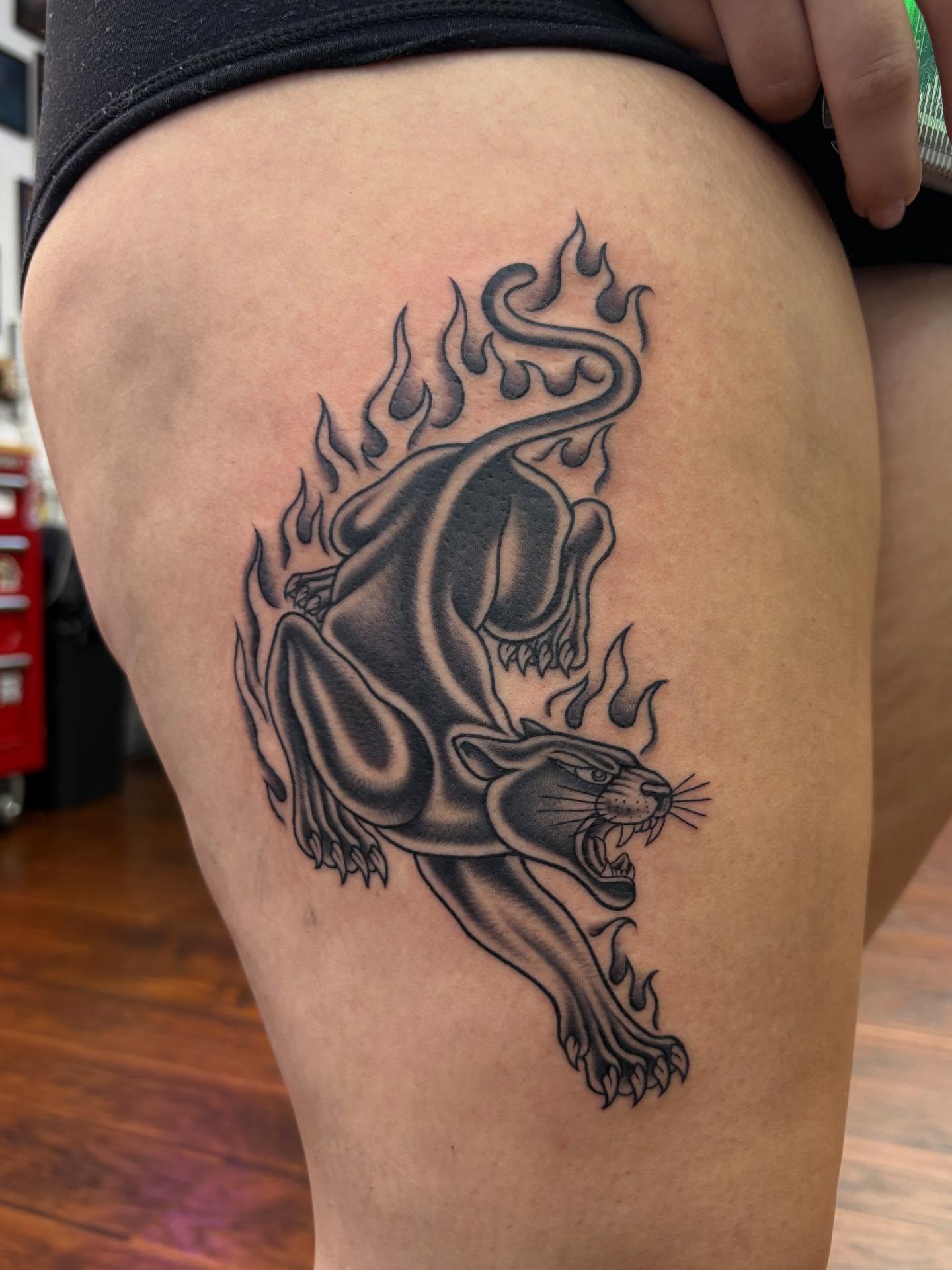 Panther black and grey tattoo on the thigh by Skye California