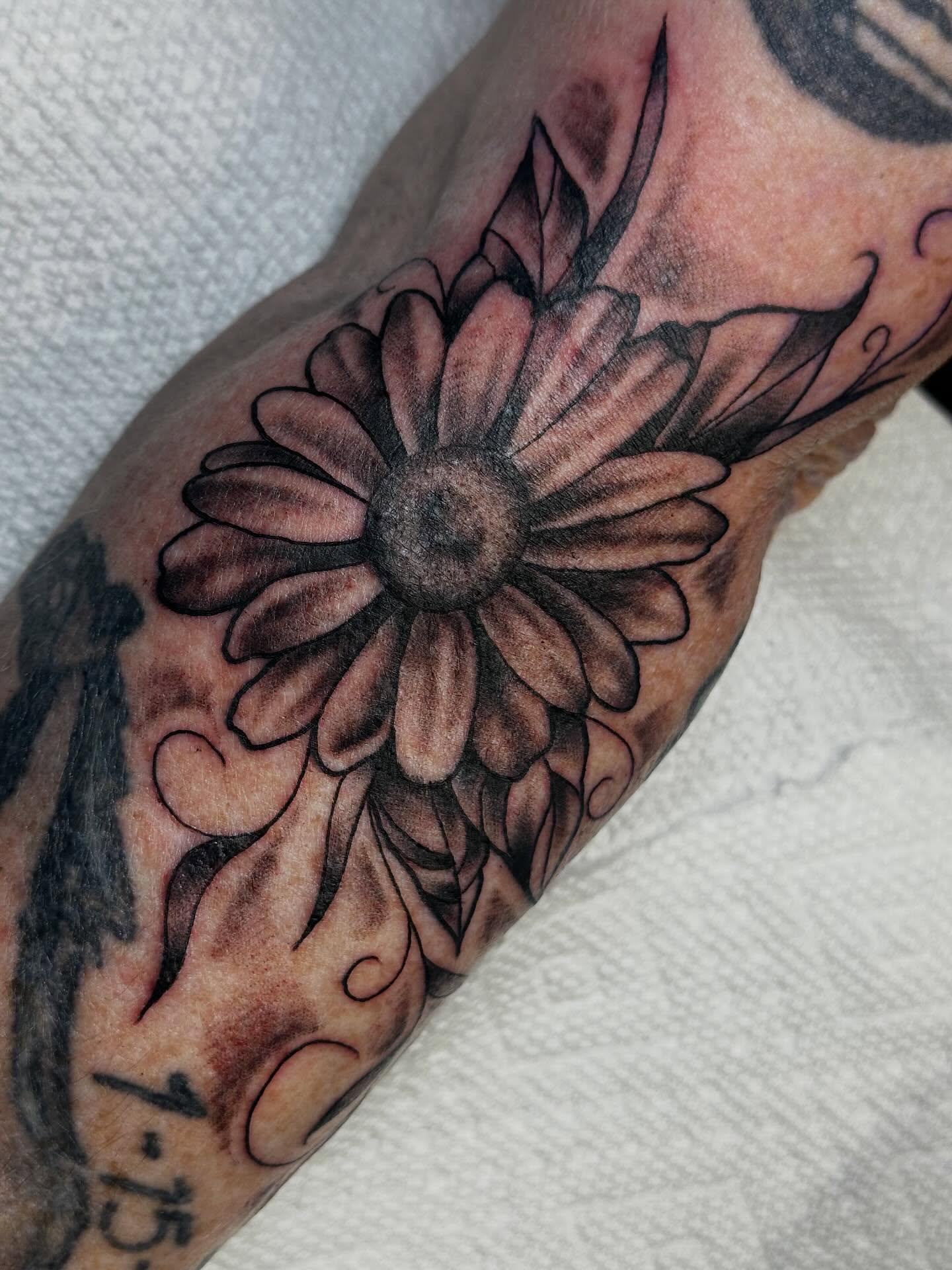 Sunflower black and grey tattoo on the forearm by Elisha B🦷