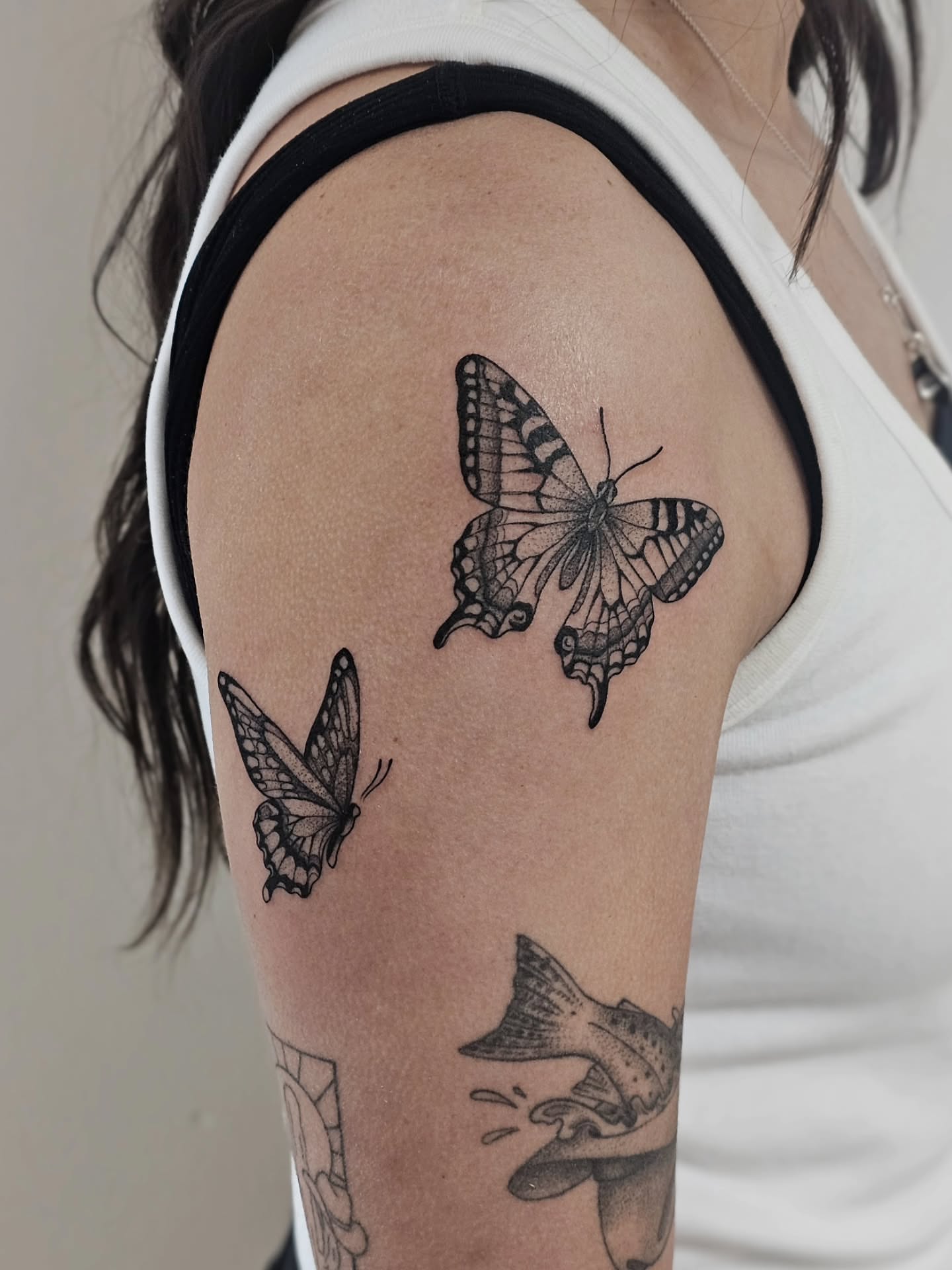 Butterflies black and grey tattoo on the shoulder by Kylie Lund