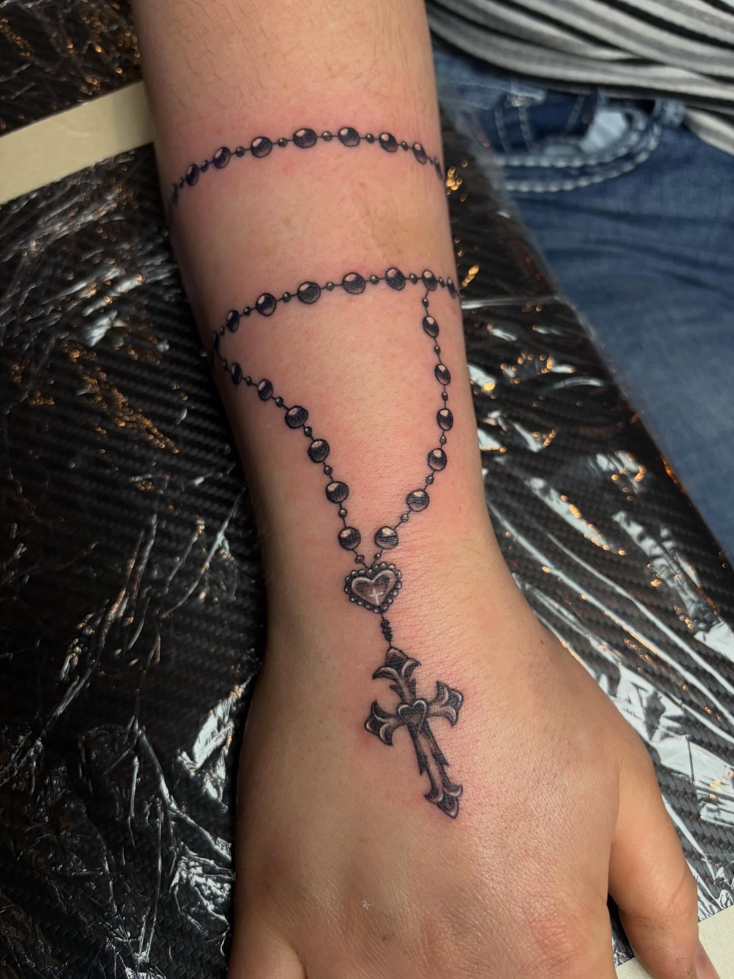 Rosary black and grey tattoo on the forearm by destany aguilera, Davenport, Iowa