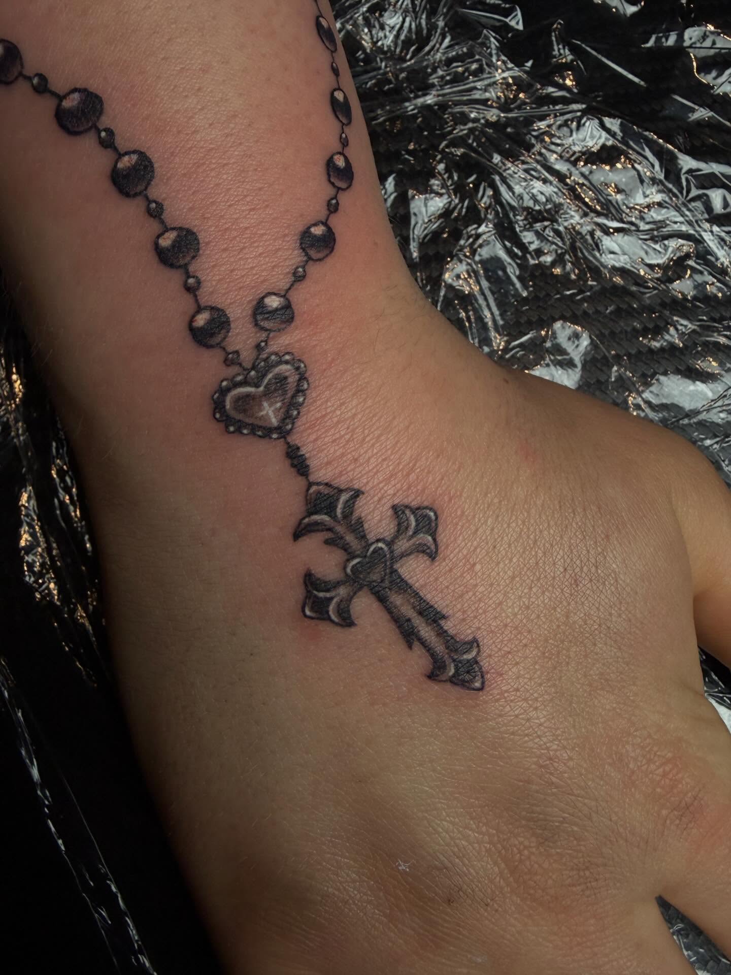 Rosary cross black and grey tattoo on the forearm by destany aguilera, Davenport, Iowa
