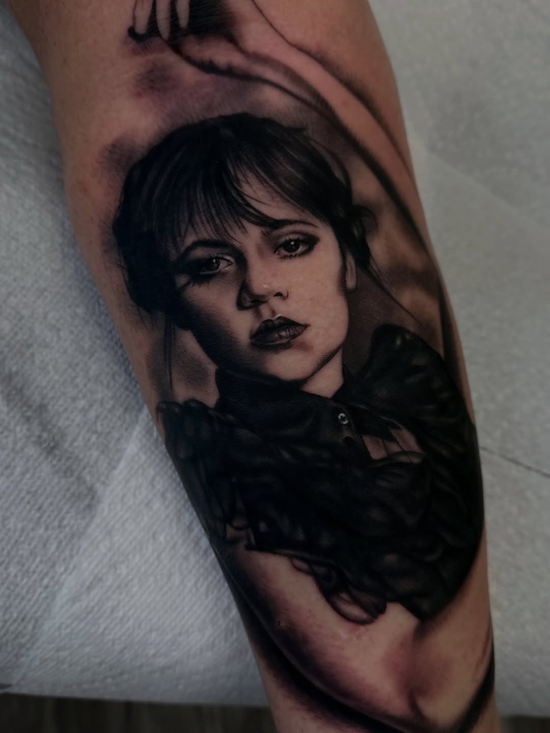 Portrait of Wednesday Addams realism tattoo on the forearm by Sacramento Tattoos (Ilona)