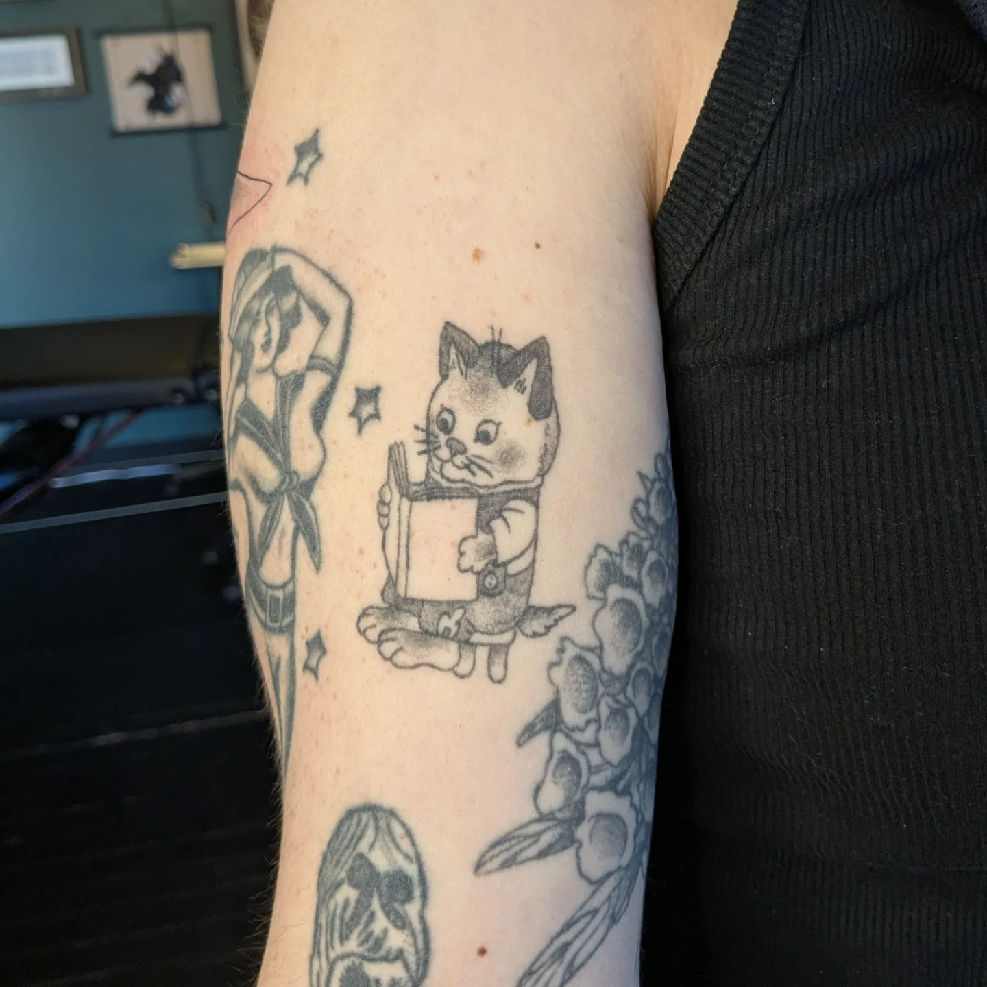 Cat reading book black and grey tattoo on the forearm by Madison Cañedo ✺ Portland tattoo