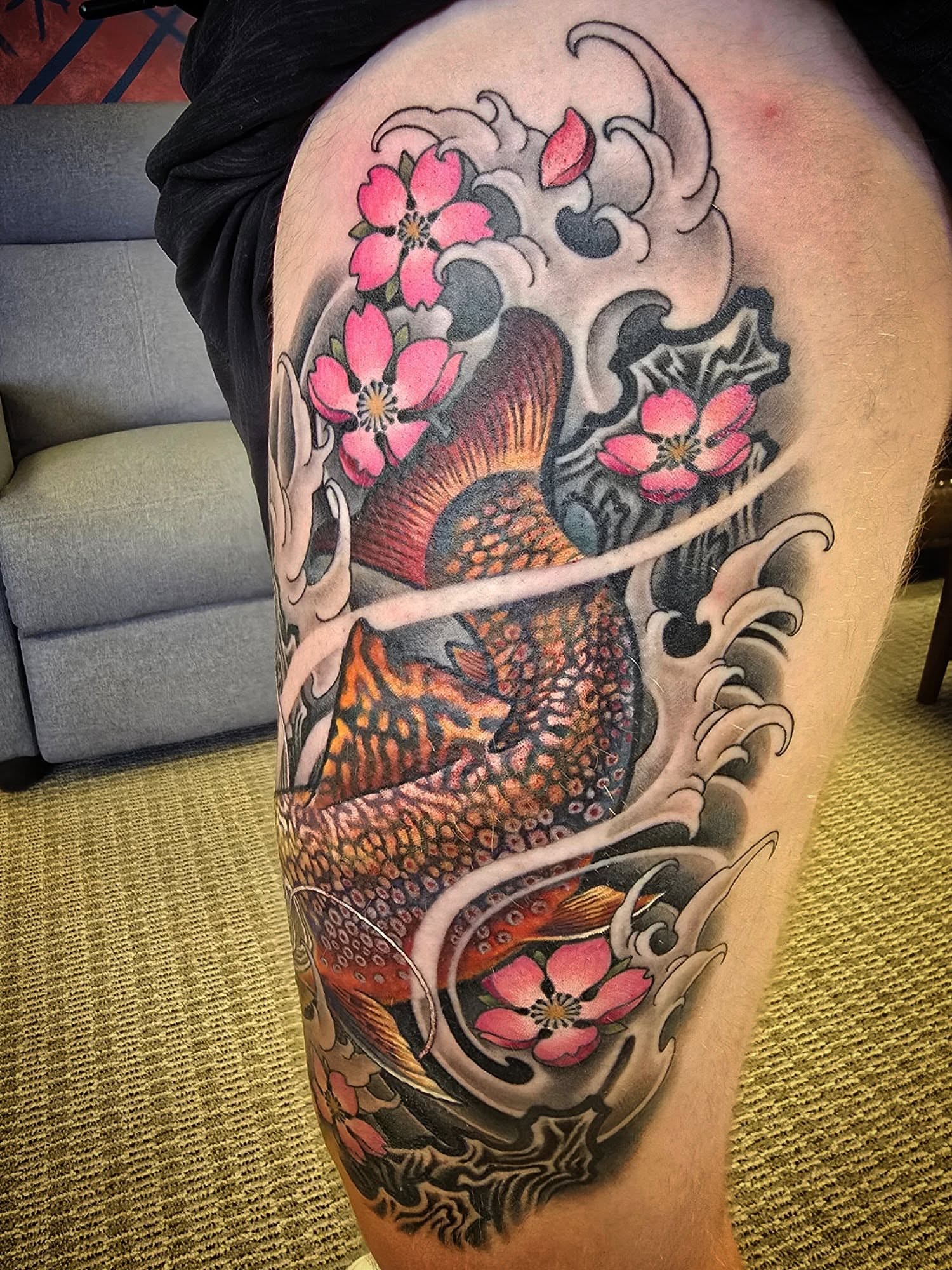 Koi fish and cherry blossoms japanese irezumi tattoo on the thigh by Alexander L. Wolff, Rapid City, South Dakota