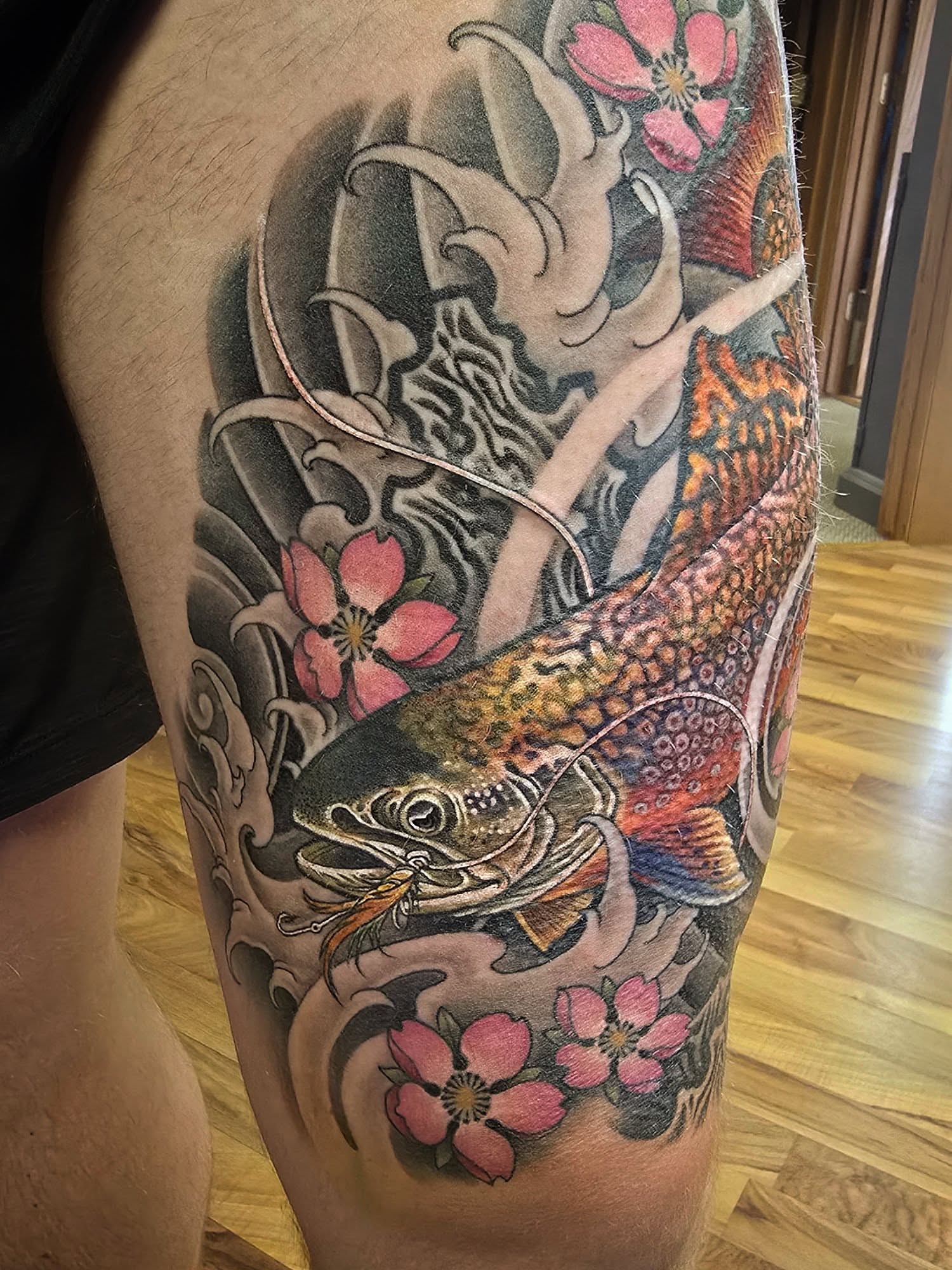 Fish and cherry blossoms japanese irezumi tattoo on the thigh by Alexander L. Wolff, Rapid City, South Dakota