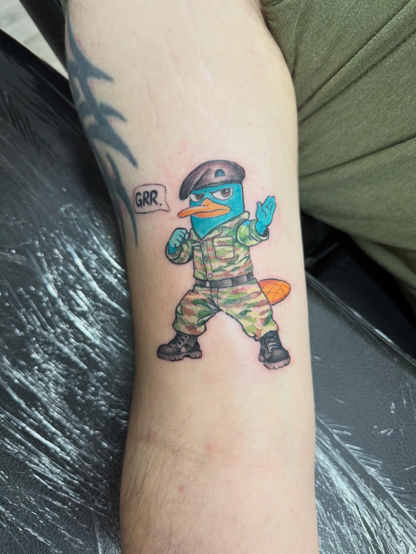 Military duck new school tattoo on the forearm by Daniel Smith