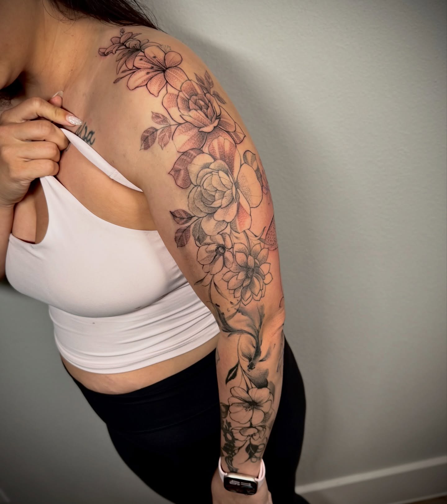 Floral bouquet black and grey tattoo on the upper arm by Lalo ink