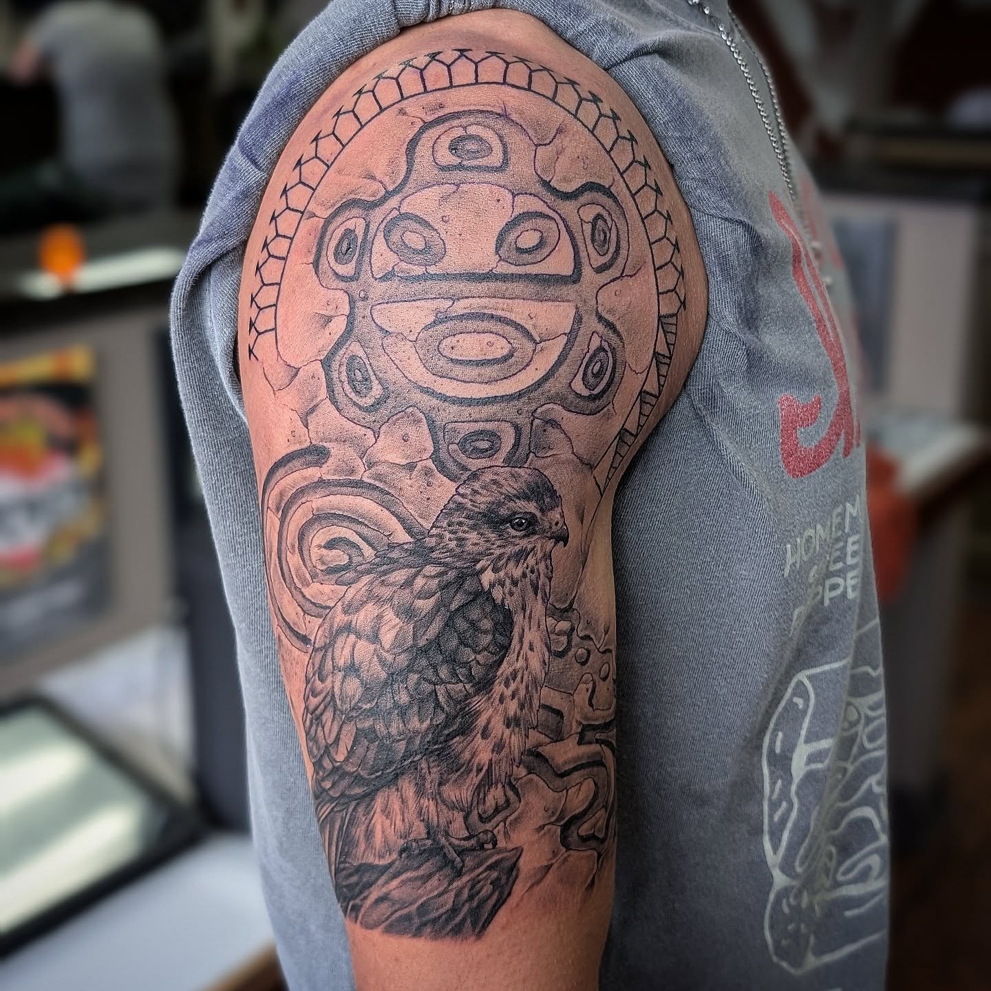 Bird and mask realism tattoo on the upper arm by Will Alexander, Lombard, Illinois