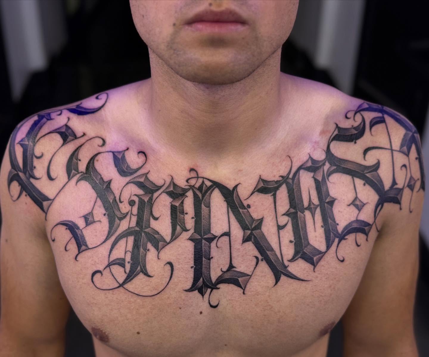 Gothic script lettering script tattoo on the chest by @nickysix86