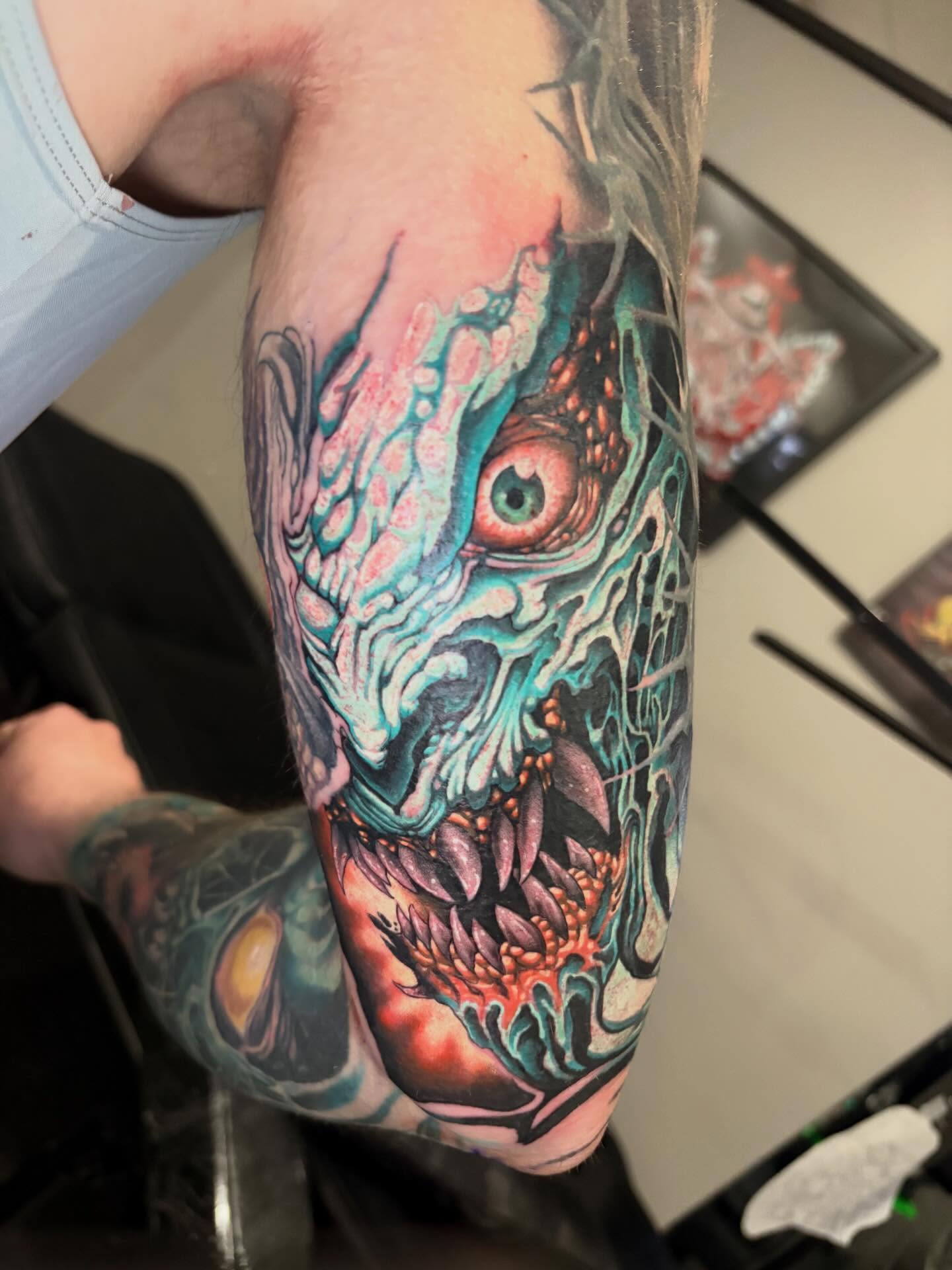 Zombie head dark realism tattoo on the forearm by Eddie Wolfe