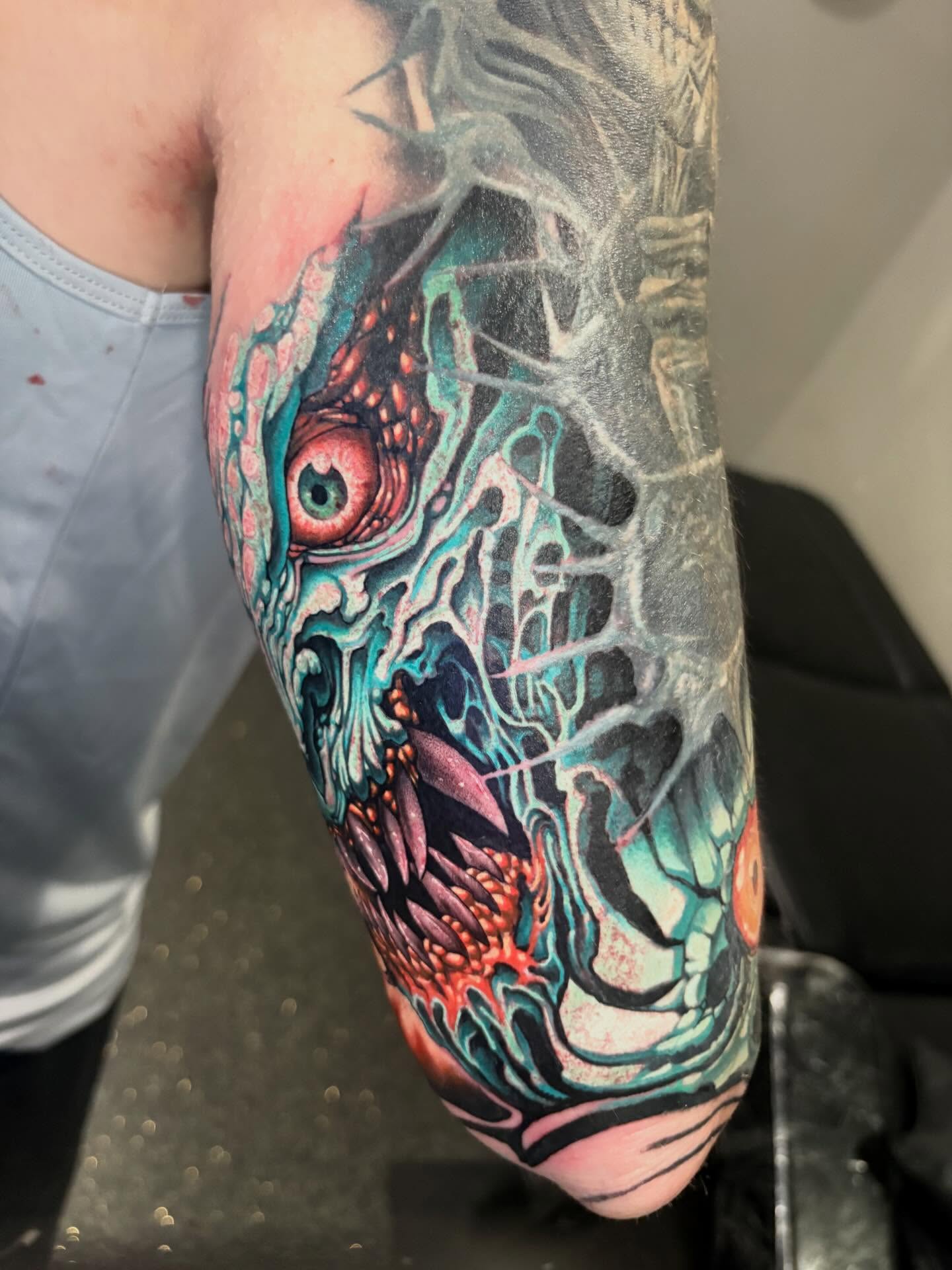 Zombie head dark realism tattoo on the forearm by Eddie Wolfe