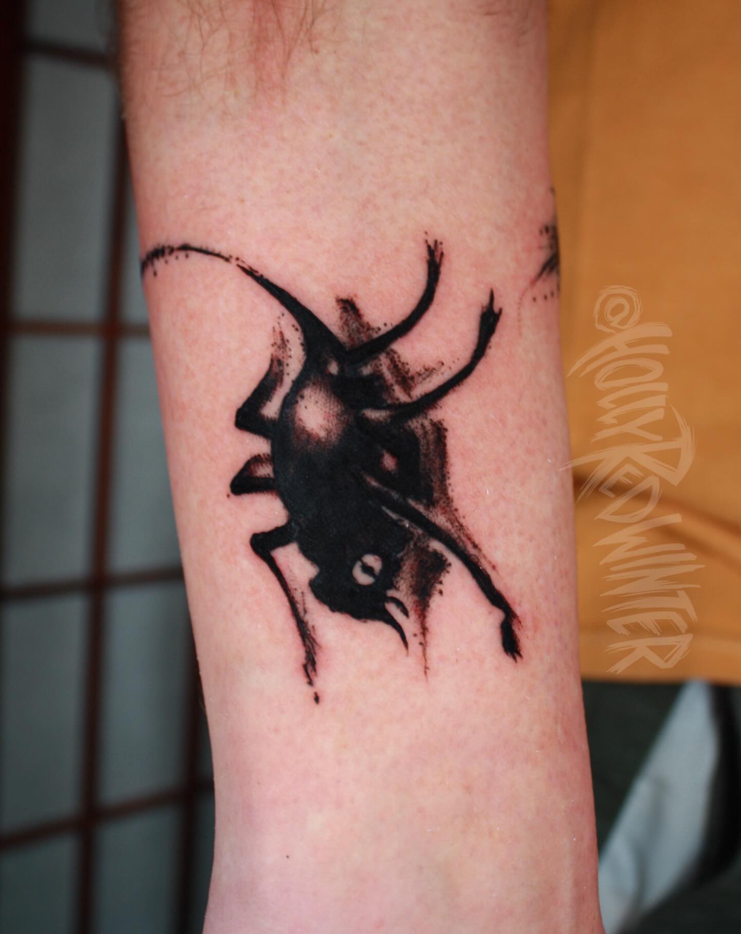 Bull black and grey tattoo on the forearm by Holly Redwinter