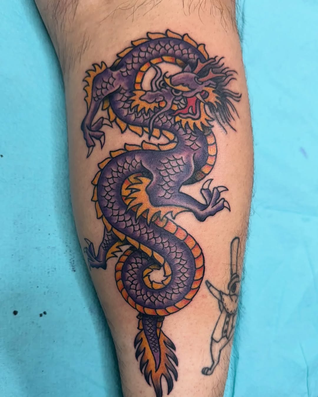 Purple dragon American traditional tattoo on the forearm by @destineey_barton