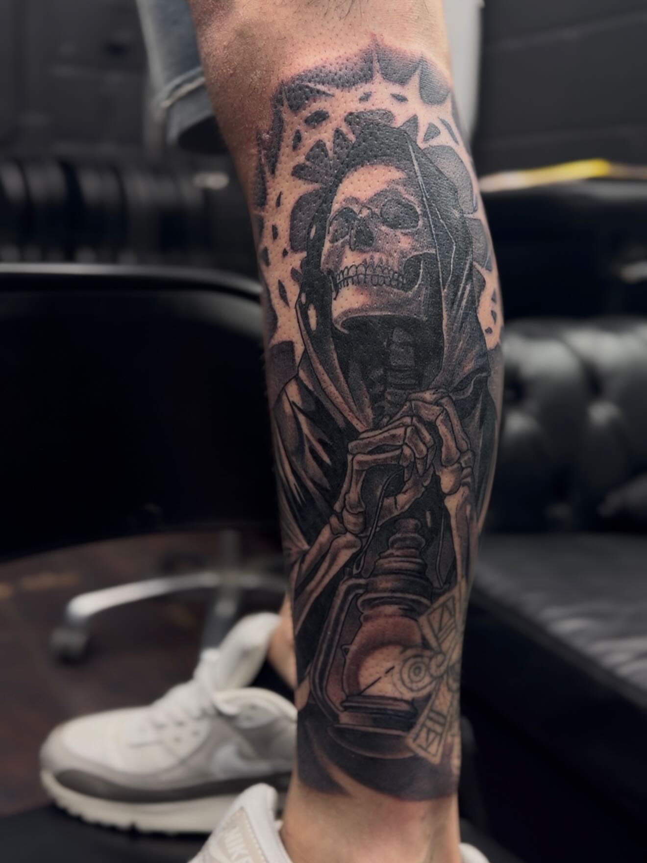 Reaper holding lantern realism tattoo on the forearm by H.G