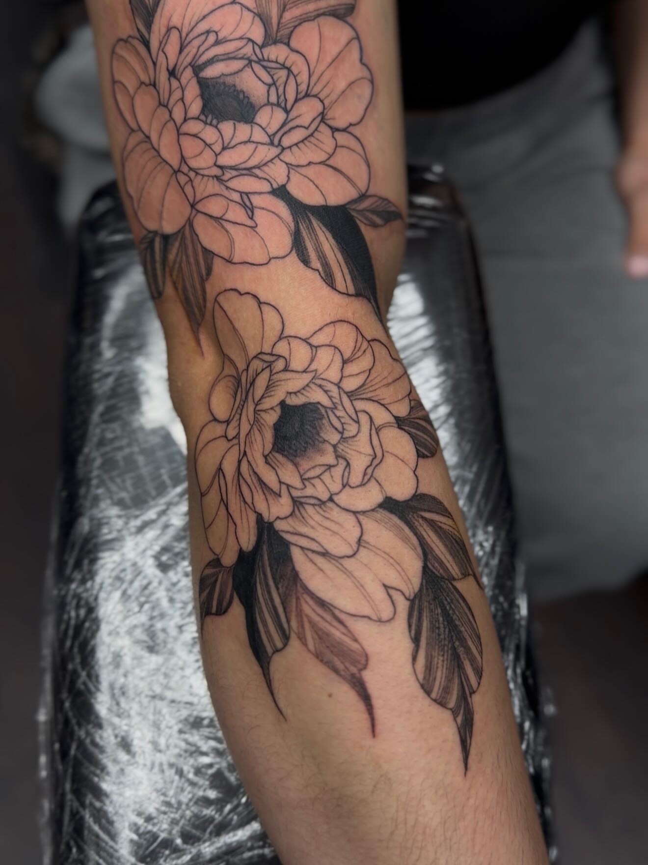 Peony flowers black and grey tattoo on the forearm by H.G