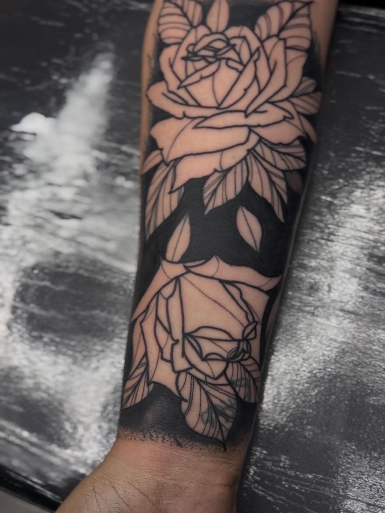 Roses black and grey tattoo on the forearm by H.G
