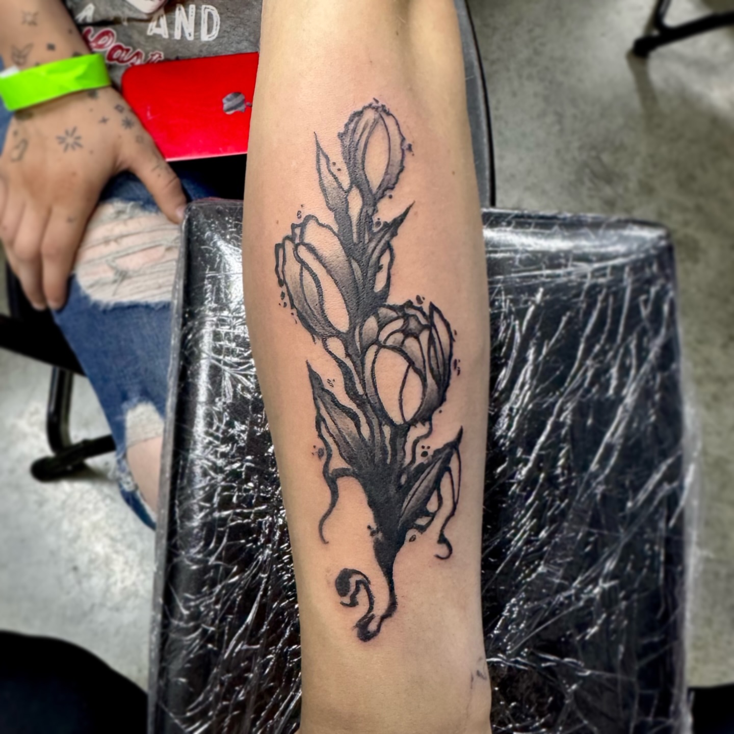 Tulips black and grey tattoo on the forearm by Mango 🧿